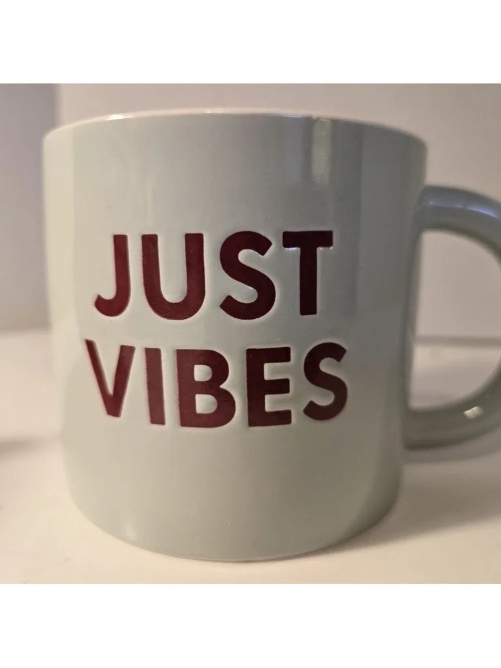 JUST VIBES Ceramic Mug in White with Maroon Lettering
